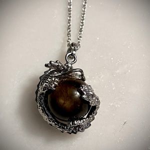 Tigers Eye Stone with dragon wrapped around it on sterling plated chain